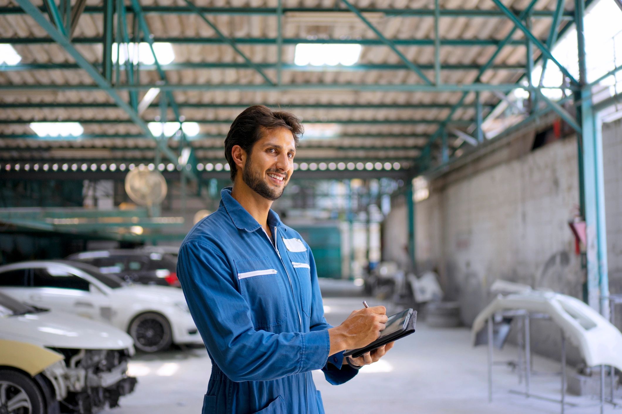 Mechanic working in a garage on vehicle electrical service