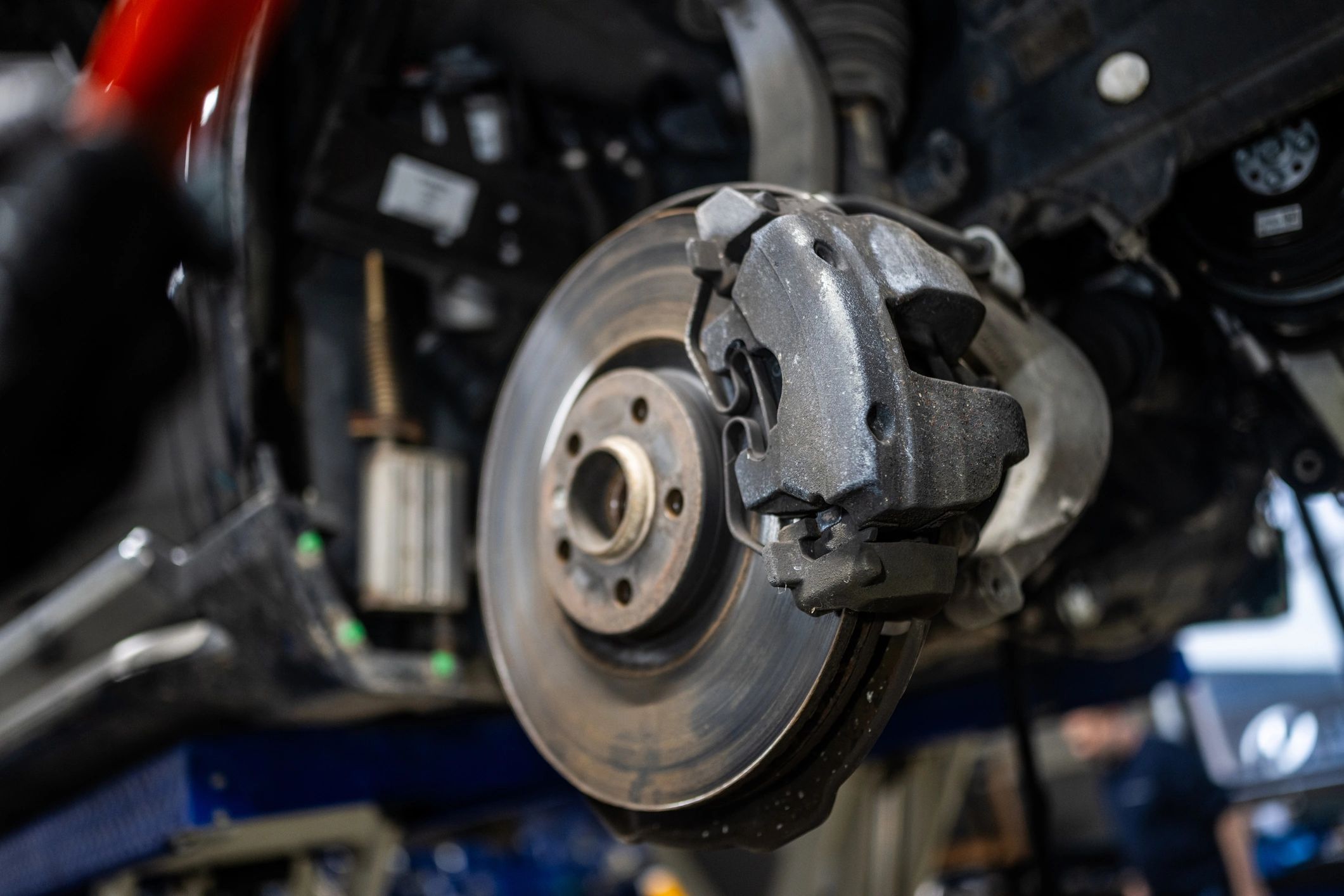 Brake disc and caliper during inspection in a repair shop